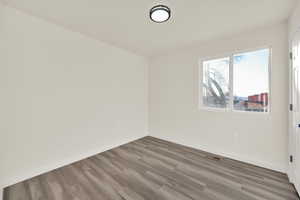 Bedroom with textured ceiling and wood finished floors