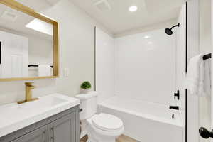 Hall Bathroom with shower / bath combination, vanity, and new toilet