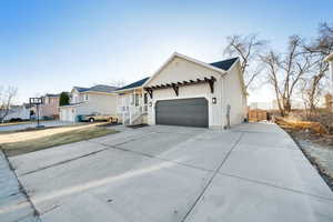 Ranch-style house featuring a 2 car garage, with RV pad for additional parking