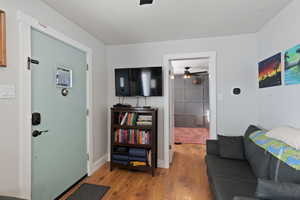 Living room featuring ceiling fan, baseboards, and wood finished floors