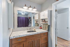 Full bathroom with wood finished floors and vanity