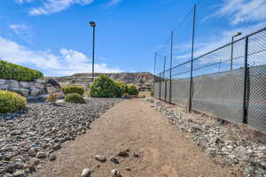 View of yard with fence and a mountain view