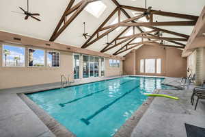 Community pool featuring ceiling fan and a skylight