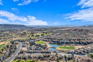 Birds eye view of property featuring a water and mountain view and a residential view