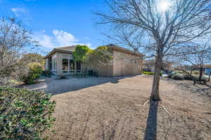 Back of house with central AC and stucco siding