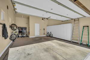 Garage with baseboards and a garage door opener