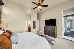 Bedroom with high vaulted ceiling, visible vents, access to exterior, baseboards, and carpet