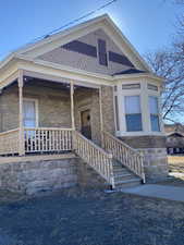 View of front facade with covered porch and brick siding