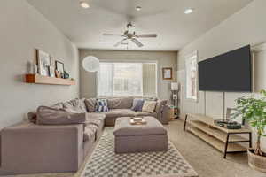 Living room featuring light carpet, ceiling fan, and recessed lighting