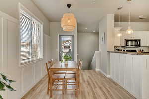 Dining space with light wood-type flooring and baseboards