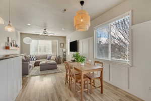 Dining space featuring recessed lighting, a decorative wall, light wood finished floors, and ceiling fan