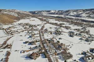 Snowy aerial view featuring a mountain view