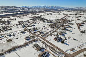 Snowy aerial view featuring a mountain view