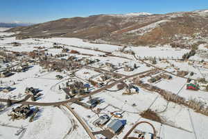 Snowy aerial view with a residential view and a mountain view