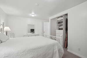 Bedroom featuring carpet flooring and baseboards