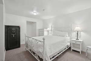 Bedroom featuring carpet and baseboards