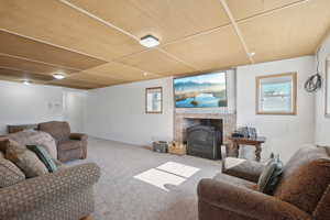 Living area with a wealth of natural light, baseboards, and carpet flooring