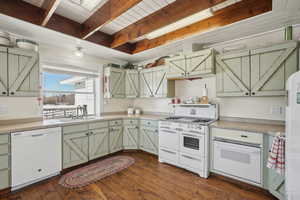 Kitchen with white appliances, dark wood-type flooring, a sink, light countertops, and beamed ceiling