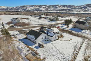 Snowy aerial view featuring a mountain view