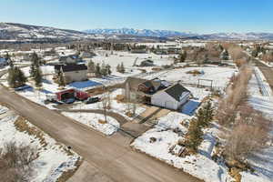 Snowy aerial view with a residential view and a mountain view