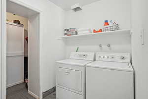 Washroom with laundry area, washer and clothes dryer, and baseboards