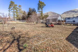 View of yard with fence and a mountain view