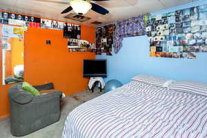 Bedroom with ceiling fan and carpet