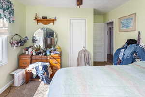 Bedroom featuring carpet and baseboards