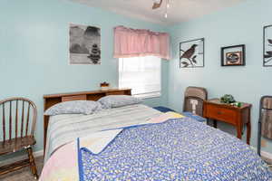 Bedroom with carpet floors, a ceiling fan, and baseboards