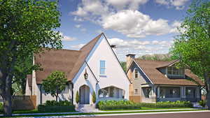 Tudor home featuring a chimney and stucco siding