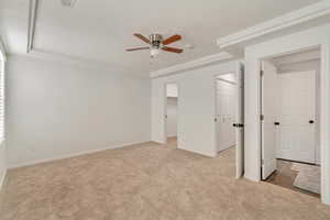 Unfurnished bedroom featuring a ceiling fan, carpet, baseboards, and two closets