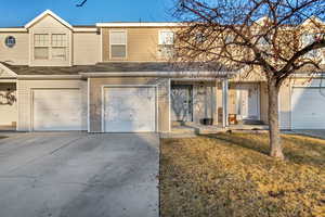 Townhome / multi-family property with a garage and driveway