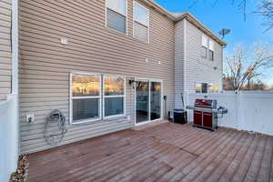 Deck with grilling area, fence, and cooling unit