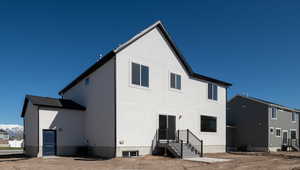 Rear view of house with central AC and stucco siding