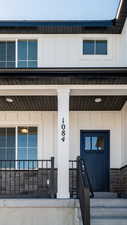 Entrance to property featuring board and batten siding and stone siding