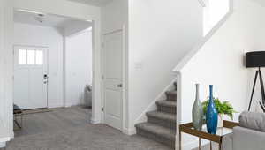 Stairs featuring carpet, baseboards, and wood finished floors