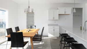 Dining space featuring an inviting chandelier and wood finished floors