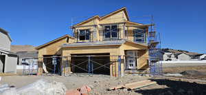 Property in mid-construction featuring fence and stucco siding