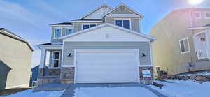 Craftsman house featuring stone siding, board and batten siding, and an attached garage