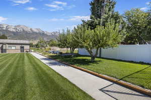 View of yard with fence and a mountain view