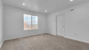 Spare room with baseboards, visible vents, carpet flooring, and recessed lighting