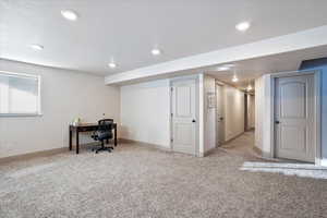 Home office featuring recessed lighting, light colored carpet, a textured ceiling, and baseboards