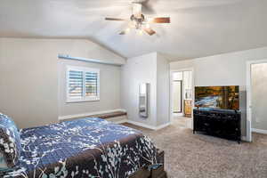 Bedroom with carpet, lofted ceiling, and baseboards