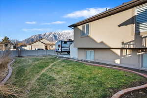 View of yard with fence and a mountain view