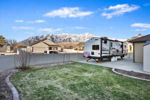 View of yard with a patio area, a fenced backyard, and a mountain view