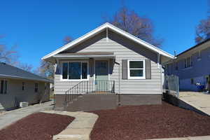 Bungalow-style house with central air condition unit