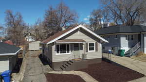 Bungalow-style house featuring central air condition unit, a chimney, and concrete driveway