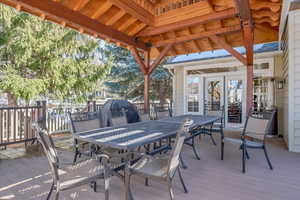 Covered  deck, french doors, and outdoor dining space perfect for entertaining