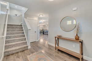 Stairway featuring baseboards and wood finished floors