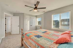 Bedroom with carpet floors, a closet, visible vents, a ceiling fan, and baseboards